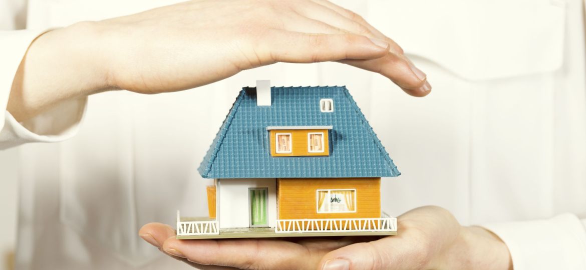 Hand,Hovering,Small,Family,House,,Home,Insurance,Concept